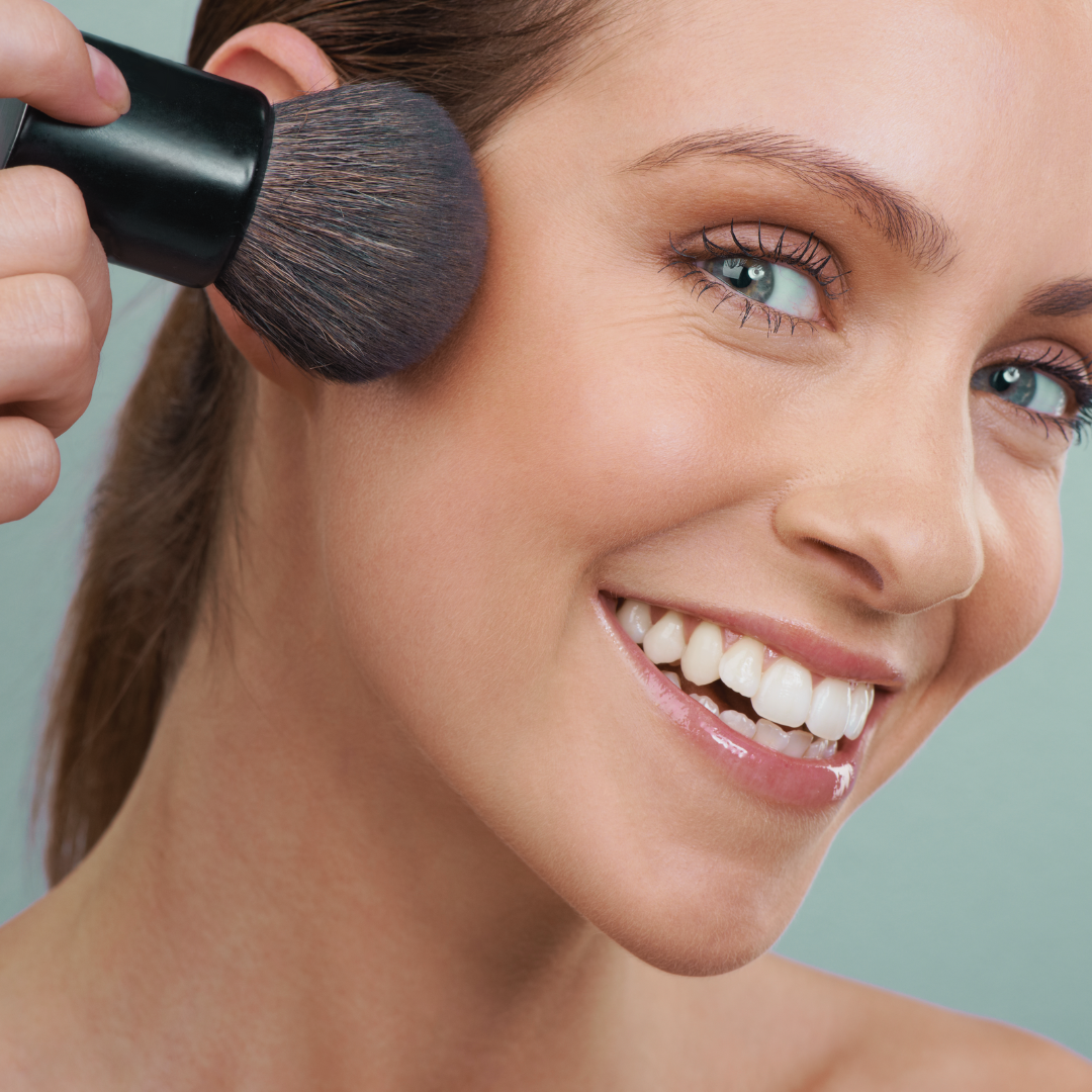 woman applying bronzer for summer make up
