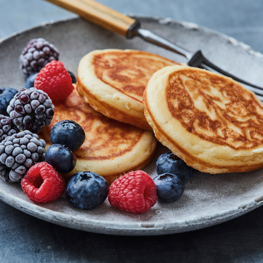 plate of protein pancakes with berries