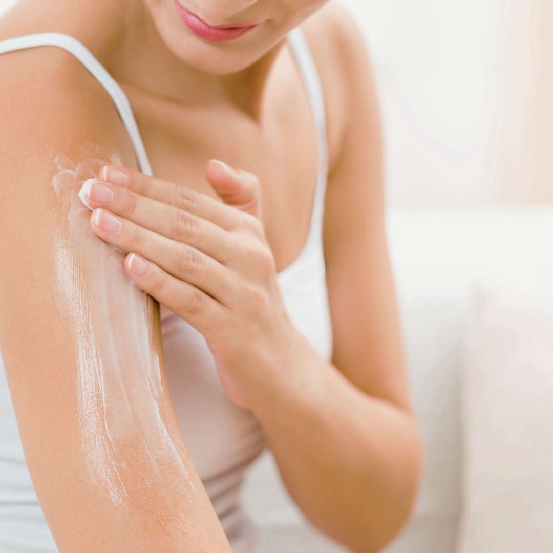 woman applying body care moisturizer
