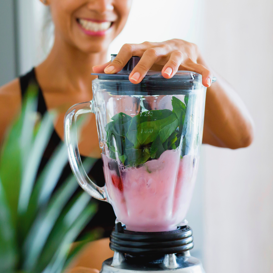woman making a protein smoothie to support a sustainable wellness routine