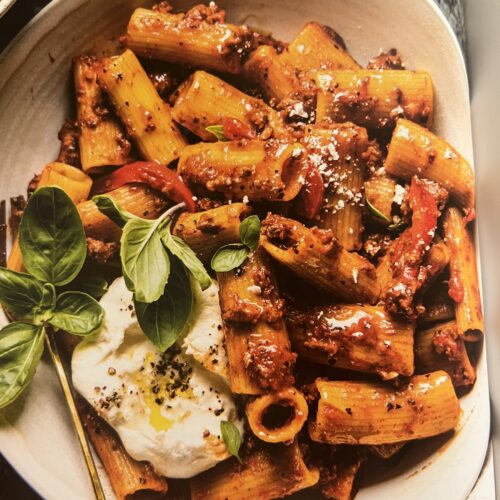 Roasted Red Pepper Bolognese with rigatoni, burrata, roasted peppers, and fresh basil.