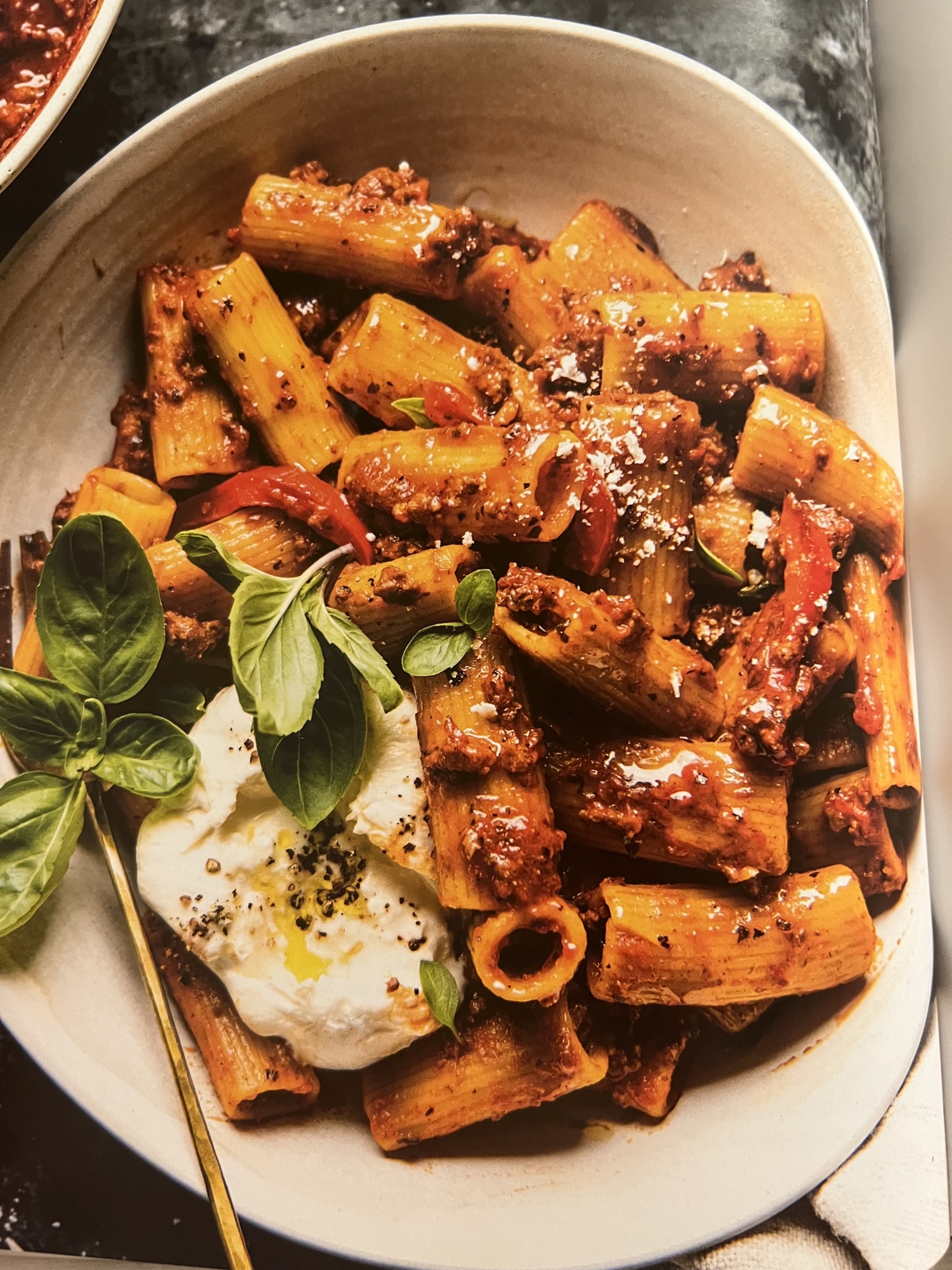 Roasted Red Pepper Bolognese with rigatoni, burrata, roasted peppers, and fresh basil.